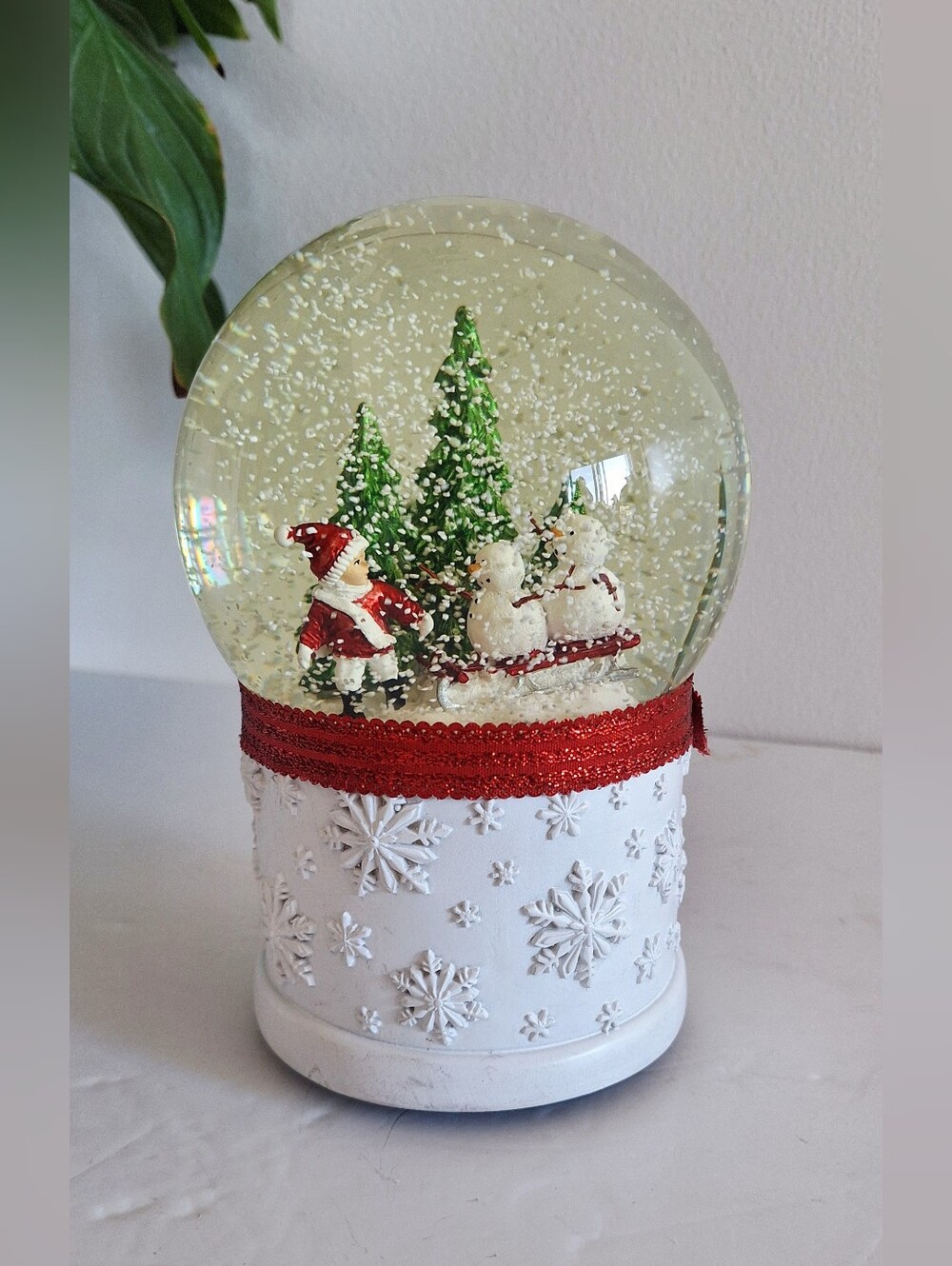 Glass snow globe with a resin base